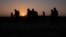 FILE - The sun rises as asylum-seeking migrant families from Honduras and El Salvador walk toward the border wall after crossing the Rio Grande into the United States from Mexico on a raft in Penitas, Texas, on March 26, 2021. 