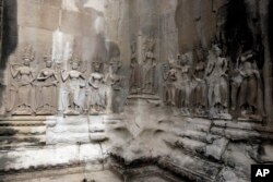 In this July 19, 2012 photo, Apsara sculptures are carved on a wall of the Angkor Wat temple complex in Siem Reap, northwest of Phnom Penh, Cambodia.
