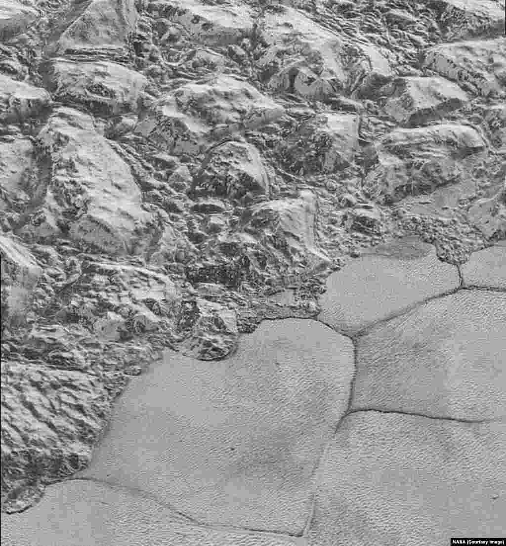 In this highest-resolution image from NASA’s New Horizons spacecraft, great blocks of Pluto’s water-ice crust appear jammed together in the informally named al-Idrisi mountains, released Dec. 4, 2015.. 