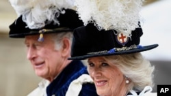 FILE - Britain's Prince Charles and Camilla, Duchess of Cornwall arrive for the Order of the Garter service at Windsor Castle, in Windsor, England, June 13, 2022.