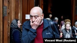 Reaksi seorang pria saat meninggalkan misa bagi para korban pelecehan seksual oleh para pastur di Bilbao, Spanyol, Jumat, (24 Maret 2023. Uskup Bilbao Joseba Segura dan pater Josu Lopez Villaiba, yang juga korban pelecehan seksual, memimpin misa itu. (Foto: Vincent West/Reuters)