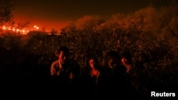 Migrants from Guatemala cross the Rio Bravo with the intention of turning themselves in to U.S. Border Patrol agents to request asylum, in El Paso, Texas, Sept. 22, 2023.