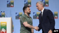 NATO Secretary-General Jens Stoltenberg shakes hands with Ukrainian President Volodymyr Zelenskyy after a joint press conference on the sidelines of the NATO Summit in Vilnius, July 12, 2023.