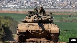 An Israeli army battle tank moves at a position along the border between southern Israeli and the Gaza Strip on Jan. 31, 2024. 