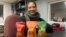 Patrice Cunningham, founder and CEO of Tae-Gu Kimchi, poses in her Washington office with three bags of the kimchi she makes and distributes with her mother, Jan. 24, 2024.