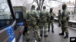 FILE - NATO peacekeeping EUFOR troops stop as they patrol in downtown Sarajevo, Bosnia, March 7, 2022. 
