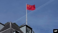 FILE - Chinese national flag is raised at the Chinese embassy in London, Sept. 11, 2023.