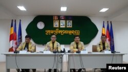 FILE - Members of the Constitutional Council of Cambodia announces the election disqualification of the Candlelight Party for the upcoming election in Phnom Penh, Cambodia, May 25, 2023.