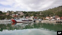 FILE - Vessels are docked at the port of Shengjin, northwestern Albania, Nov. 7, 2023, one of two proposed places to house migrants.