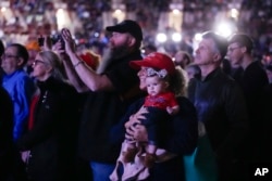 Supporters listen as Republican presidential candidate and former President Donald Trump speaks at the National Rifle Association's Presidential Forum in Harrisburg, Pennsylvania, Feb. 9, 2024.
