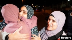 Released Palestinian prisoner Marah Bkeer greets a family member near her house after a hostages-prisoners swap between Hamas and Israel, in Jerusalem, Nov. 24, 2023.