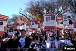 FILE - Jewish Americans and supporters of Israel hold signs as they protest against antisemitism during a rally on the National Mall in Washington on Nov. 14, 2023.