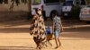 People look for water during clashes between the paramilitary Rapid Support Forces and the army in Khartoum North, Sudan, April 20, 2023. 