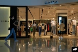 People are seen in a ZARA flagship store at a shopping mall in Beijing, June 21, 2023.
