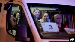 A minibus carrying Israeli hostages released by Hamas arrives at the Sheba Medical Center in Ramat Gan, Israel, Nov. 30, 2023.