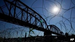 FILE - The Union Pacific International Railroad Bridge is seen behind concertina wire, Sept. 22, 2023, in Eagle Pass, Texas. 