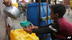 A boy gets drinking water during the ongoing Israeli bombardment of the Gaza Strip in Rafah, Oct. 28, 2023. Overcrowding and a lack of clean drinking water and sanitation in Gaza has created a breeding ground for infectious disease, according to the WHO.