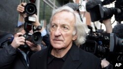 FILE - Journalist John Pilger, who was a supporter of Wikileaks founder Julian Assange, arrives at the City of Westminster Magistrates Court in London where Assange was in court for a bail hearing, Dec. 14, 2010. Pilger died Saturday at 84.