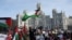FILE - People attend a protest calling for a cease-fire in Gaza, amid the ongoing conflict between Israel and the Palestinian Islamist group Hamas, outside Cibeles Palace in Madrid, Jan. 27, 2024.