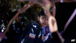 A group of asylum-seekers from Ecuador wait in a makeshift camp after crossing the nearby border with Mexico, Sept. 20, 2023, near Jacumba Hot Springs, Calif.