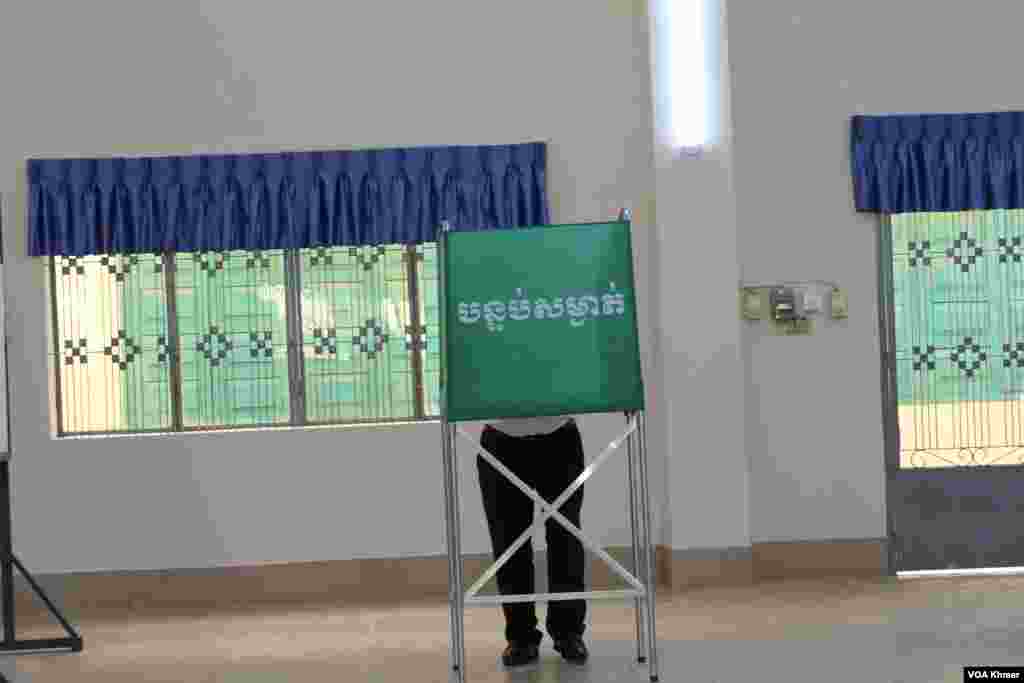 ពលរដ្ឋម្នាក់កំពុងបោះឆ្នោត នៅក្នុងការបោះឆ្នោតជាតិអាណត្តិទី ៧ ដែលអវត្តមានគណបក្សប្រឆាំងដ៏ធំមួយ នៅក្រុងតាខ្មៅ ខេត្តកណ្តាល ថ្ងៃទី ២៣ ខែកក្កដា ឆ្នាំ ២០២៣។ (លាស់ លីបលីប/វីអូអេ)