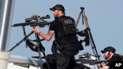 Police snipers return fire after shots were fired while Republican presidential candidate former President Donald Trump was speaking at a campaign event in Butler, Pennsylvania, July 13, 2024. 