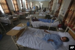 Injured people lie on the bed at a hospital after Sunday's suicide bomber attack, in the Bajaur district of Khyber Pakhtunkhwa, Pakistan, July 31, 2023.