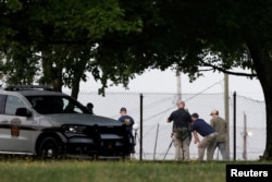 A member of the FBI Evidence Response Team works near the building where a gunman was shot dead by law enforcement in Butler, Pennsylvania, July 15, 2024.