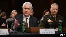 FILE - CIA Director William Burns, left, testifies during a Senate Intelligence Committee hearing on worldwide threats in Washington on March 8, 2023. Burns traveled to Qatar on Nov. 28, 2023, for talks on the truce between Israel and Hamas. 