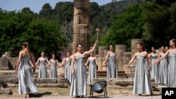 Performers take part in the final dress rehearsal of the flame lighting ceremony for the Paris Olympics, at the Ancient Olympia site, Greece, April 15, 2024. 