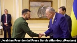 Ukraine's President Volodymyr Zelenskyy and U.S. Senate Majority Leader Chuck Schumer shake hands during a meeting amid Russia's attack on Ukraine, in Lviv, Ukraine, Feb. 23, 2024.