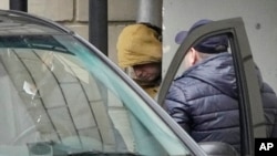 Novinar dnevnika Vol strit žurnal napušta sudnicu u pratnji bezbjednjaka (Foto: AP/Alexander Zemlianichenko)