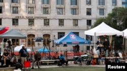 Media is stationed outside the Lewis R. Slaton Courthouse after a grand jury brought back indictments against former president Donald Trump, in Atlanta, Georgia, Aug. 15, 2023.