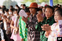 Cambodian women workers participate in an event to celebrate International Women's Day with a theme of "Support women and girls for the justice of all," on Wednesday, March 8, 2023 in Phnom Penh, Cambodia. (AP Photo/Heng Sinith)