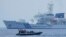 FILE - A Philippine Coast Guard rigid hull inflatable boat passes by the Japanese Coast Guard Akitsushima during a trilateral Coast Guard drill of the U.S., Japan and Philippines near the waters of the disputed South China See in Bataan province, Philippines, June 6, 2023.