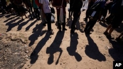 FILE - Migrants wait to be processed by the U.S. Customs and Border Patrol after they crossed the Rio Grande and entered the U.S. from Mexico, Oct. 19, 2023, in Eagle Pass, Texas. 