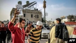 FILE - A man assists another to carry an intravenous solution bag for him as they walk outside the Ahli Arab hospital in Gaza City on March 27, 2024