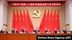 Members of the Politburo Standing Committee from left, , Li Xi, Cai Qi, Zhao Leji, Xi Jinping, Li Qiang, Wang Huning and Ding Xuexiang attend the third plenary session of the 20th Communist Party of China Central Committee in Beijing, July 18, 2024. 