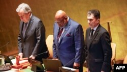 U.N. Secretary-General António Guterres, left, stands during a moment of silence during a United Nations General Assembly tribute to the late Iranian President Ebrahim Raisi at U.N. headquarters in New York on May 30, 2024. 