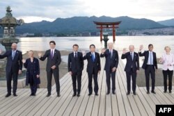 Left to right: European Council President Charles Michel, Italy's Primer Minister Giorgia Meloni, Canada's Prime Minister Justin Trudeau, France's President Emmanuel Macron, Japan's Prime Minister Fumio Kishida, U.S. President Joe Biden, German Chancellor Olaf Scholz, Britain's Prime Minister Rishi Sunak and European Commission President Ursula von der Leyen pose for a photo during a visit to the Itsukushima Shrine in Miyajima Island as part of the G7 Leaders' Summit, May 19, 2023.