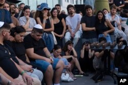 Mourners attend a funeral of the Israeli man Ziv Shapira who was killed by Hamas militants, outside a bar in Tel Aviv, Israel , Oct. 19, 2023.