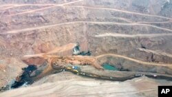 In this aerial photo released by China's Xinhua News Agency, rescuers work at the site of a collapsed open pit coal mine in Alxa League in northern China's Inner Mongolia Autonomous Region, Feb. 23, 2023.