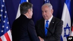 Menteri Luar Negeri AS Antony Blinken, kiri, dan PM Israel Benjamin Netanyahu berjabat tangan setelah pernyataan mereka kepada media di "Kirya", yang menampung Kementerian Pertahanan Israel, setelah pertemuan mereka di Tel Aviv 12 Oktober 2023. (Jacquelyn Martin /AP)