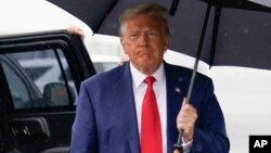 Former President Donald Trump walks over to speak with reporters before he boards his plane at Ronald Reagan Washington National Airport, Aug. 3, 2023, in Arlington, Va., after facing a judge on federal conspiracy charges.