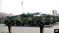 FILE - Chinese military vehicles carrying DF-17 ballistic missiles roll during a parade to commemorate the 70th anniversary of the founding of Communist China in Beijing, on Oct. 1, 2019.
