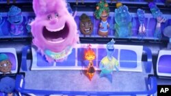 This image released by Disney/Pixar Studios shows characters Gale, center left, Ember, center, and Wade, right, in a scene from "Elemental."