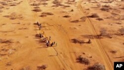 FILE - People arrive at a displacement camp on the outskirts of Dollow, Somalia, Sept. 21, 2022 amid a drought. 