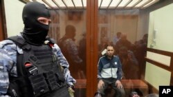 FILE - Saidakrami Murodali Rachabalizoda, a suspect in the Crocus City Hall shooting, sits in a Moscow courtroom, March 24, 2024. The attack on the hall appears to be setting the stage for an increasingly harsh response by President Vladimir Putin.