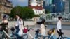 FILE - Couples prepare to get their photo taken during a wedding photography shoot on a street, in Shanghai, China Sept. 6, 2023.