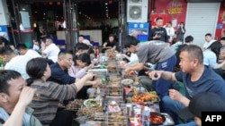 Warga China sedang makan bersama di Provinsi Shandong timur, China. (Foto: AFP)